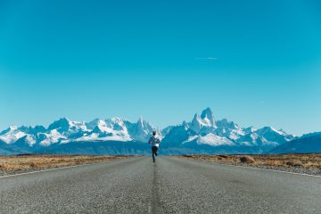 A person running toward mountains